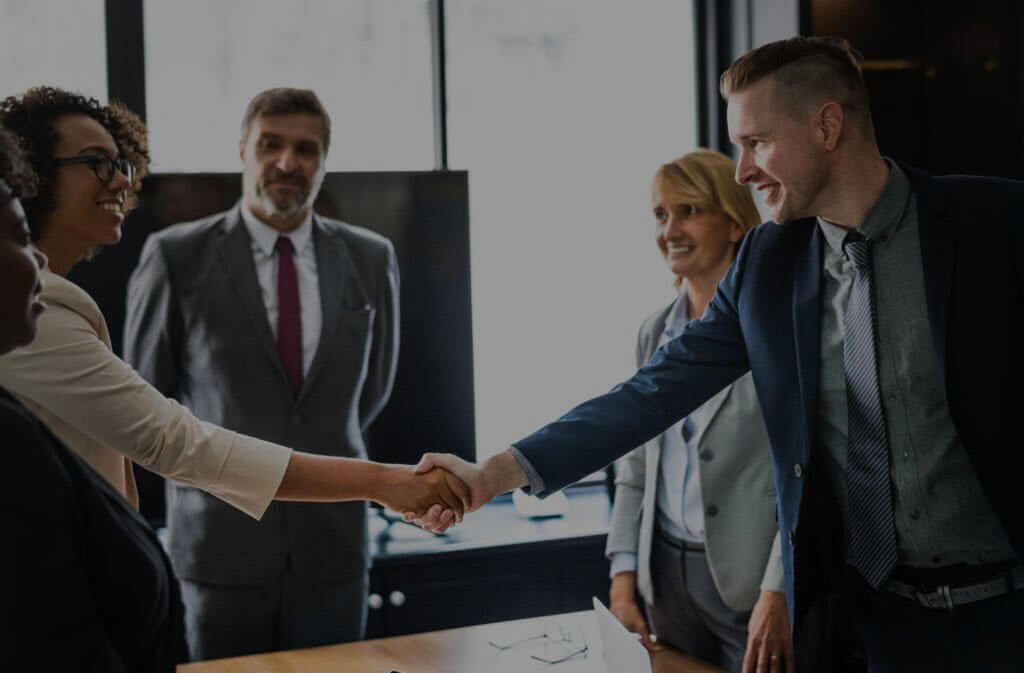 A business man and woman shaking hands